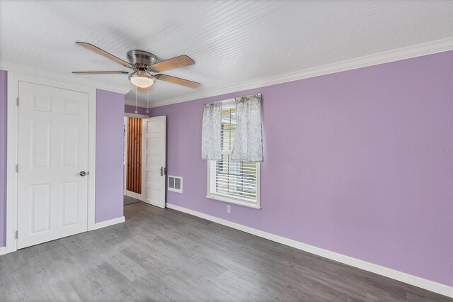 unfurnished bedroom with hardwood / wood-style flooring, ceiling fan, and ornamental molding