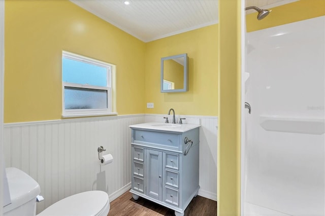 bathroom featuring wood-type flooring, vanity, and toilet