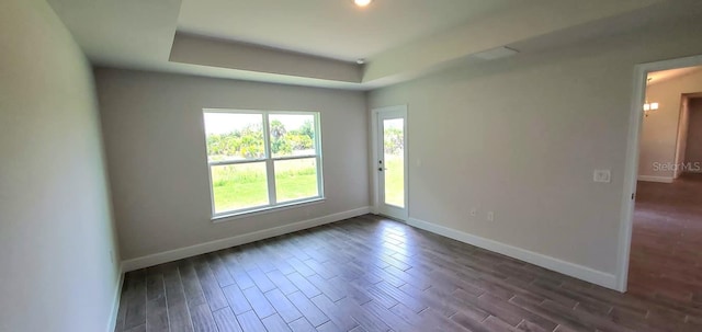 empty room with dark hardwood / wood-style flooring