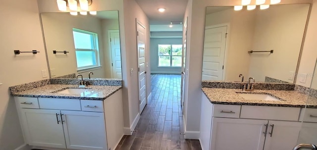 bathroom with vanity and hardwood / wood-style flooring