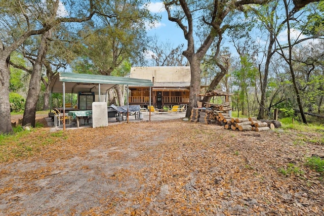 rear view of property with a carport