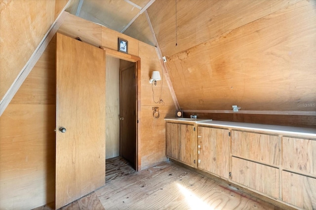 interior space with sink and vaulted ceiling