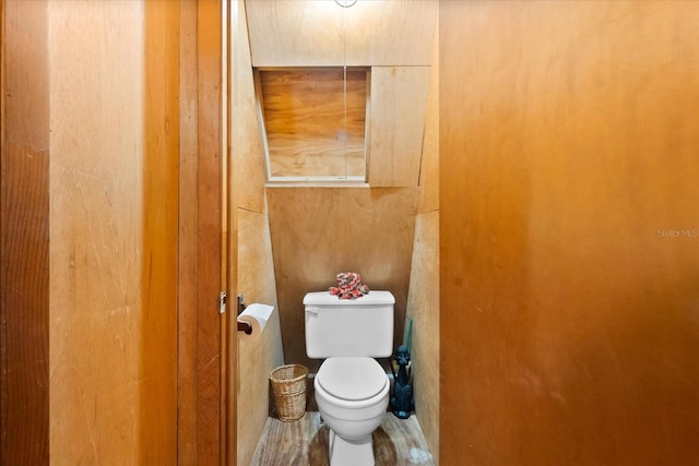 bathroom with toilet and wood-type flooring