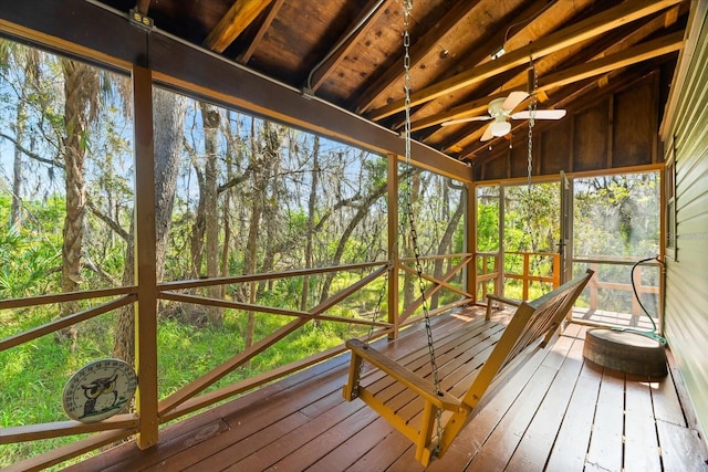 unfurnished sunroom featuring lofted ceiling with beams, ceiling fan, and wood ceiling