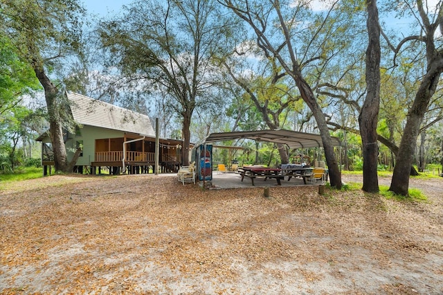 view of yard featuring a carport and a sunroom