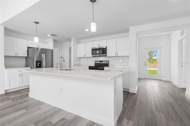 kitchen featuring white cabinetry, stainless steel appliances, a sink, and light countertops