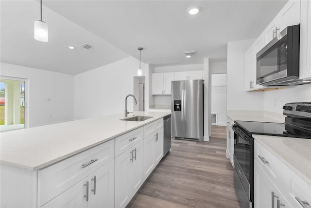 kitchen featuring a sink, stainless steel appliances, light countertops, and white cabinets