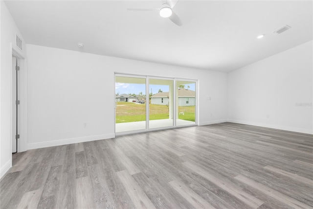 unfurnished room with light wood-type flooring, baseboards, and visible vents