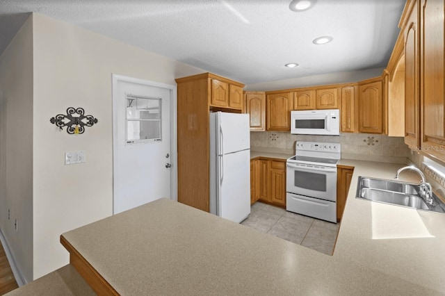 kitchen with light tile flooring, tasteful backsplash, white appliances, and sink