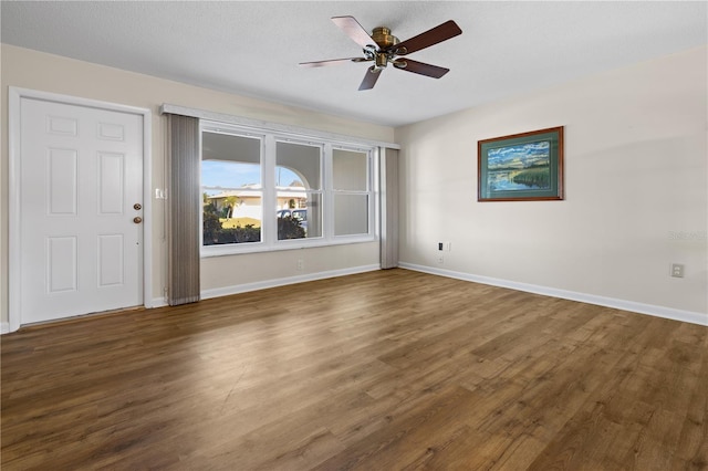 spare room featuring ceiling fan and dark hardwood / wood-style floors