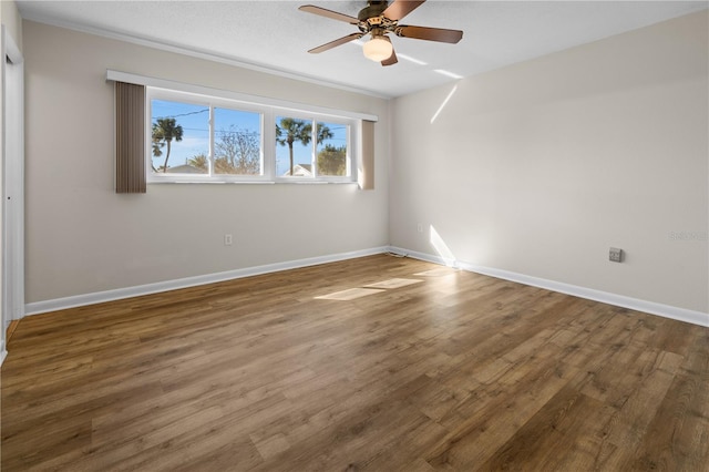 unfurnished room with dark hardwood / wood-style floors and ceiling fan