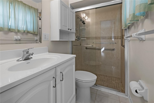 bathroom with toilet, a shower with door, vanity with extensive cabinet space, and tile flooring