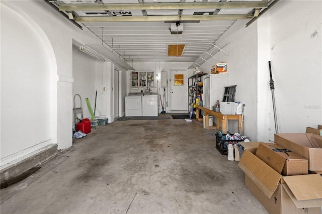 garage featuring a garage door opener and independent washer and dryer