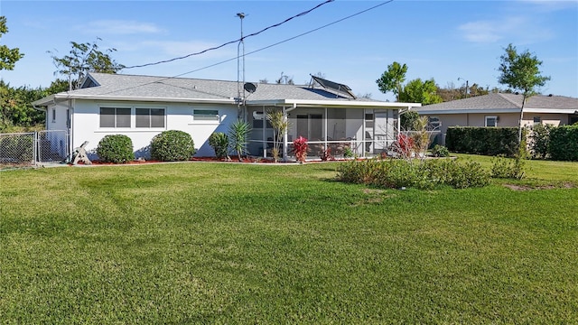 rear view of house with a yard