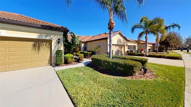 view of side of property with a lawn and a garage