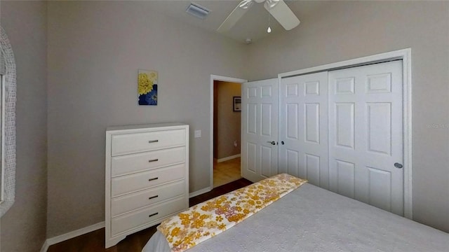 bedroom with a closet, ceiling fan, and dark wood-type flooring