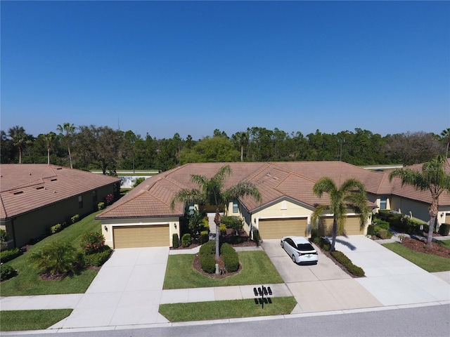 view of front of house with a front yard and a garage