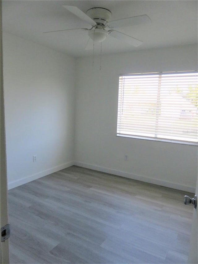 unfurnished room with light hardwood / wood-style flooring and ceiling fan