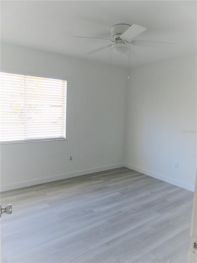 empty room featuring ceiling fan and light wood-type flooring