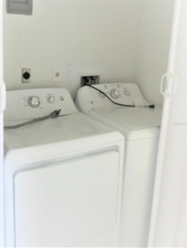 clothes washing area featuring washer hookup and washer and dryer