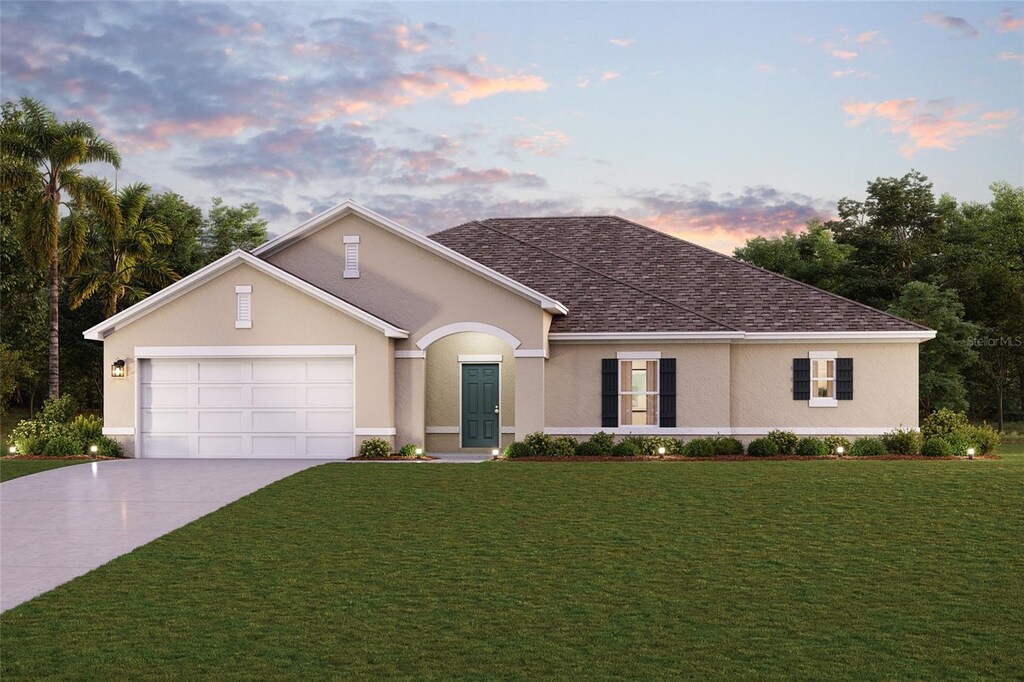 view of front of house featuring a garage and a lawn