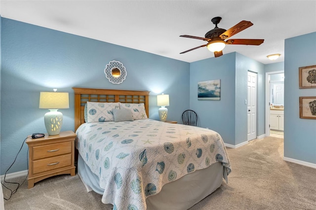 carpeted bedroom with connected bathroom and ceiling fan