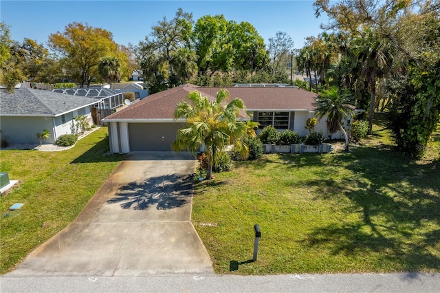 single story home featuring a garage and a front yard