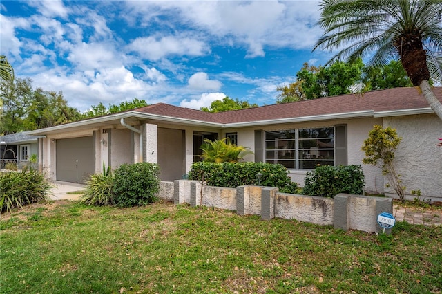 single story home featuring a garage and a front yard