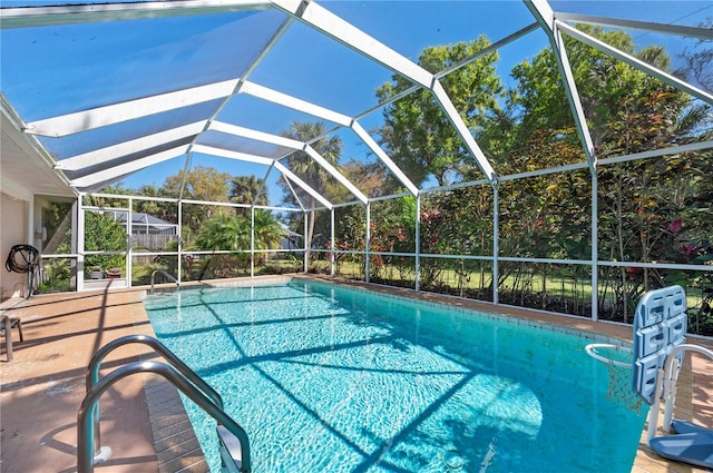 view of swimming pool featuring glass enclosure and a patio area