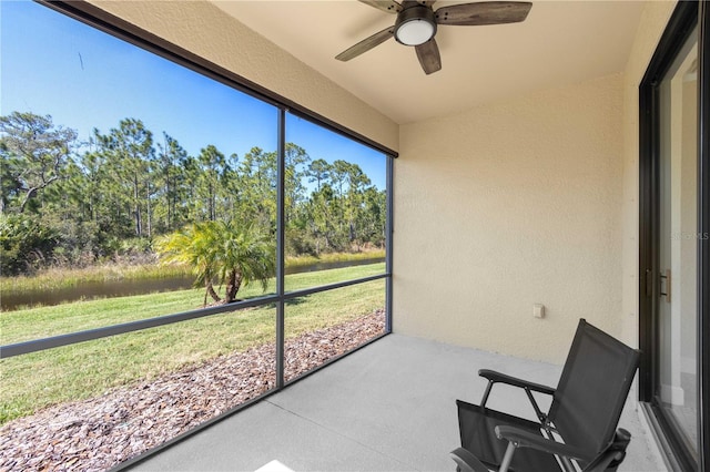 sunroom featuring ceiling fan