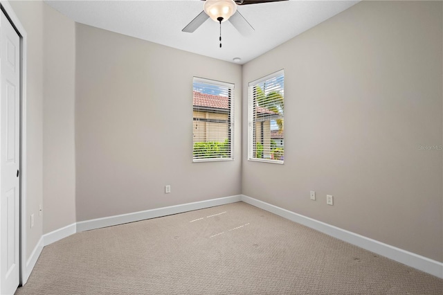 empty room with light carpet and ceiling fan