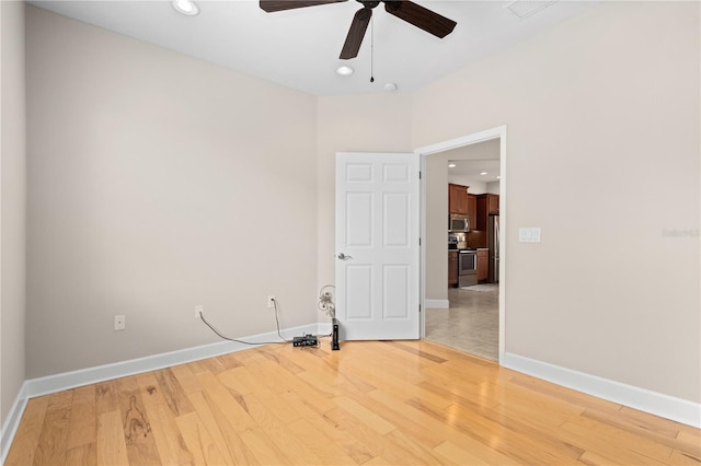 empty room with ceiling fan and wood-type flooring