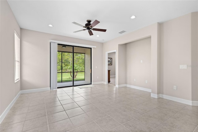 empty room featuring ceiling fan and light tile patterned floors