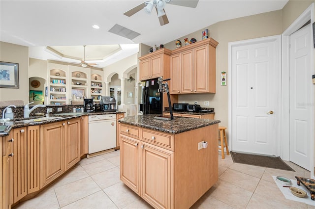 kitchen featuring white dishwasher, an island with sink, black fridge with ice dispenser, and ceiling fan