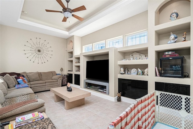 tiled living room featuring built in features, ceiling fan, and a raised ceiling