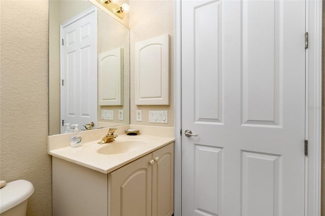 bathroom with toilet and vanity