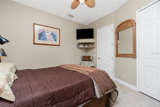 bedroom with ceiling fan and light tile floors