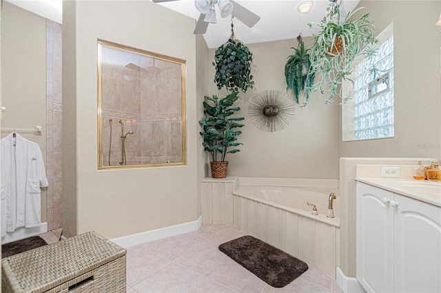 bathroom featuring tile floors, ceiling fan, vanity, and a bath to relax in