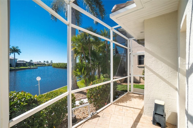 unfurnished sunroom featuring a water view