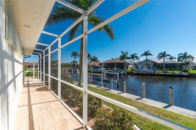 unfurnished sunroom featuring a water view