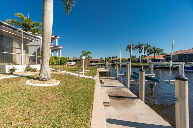 dock area with a yard and a water view