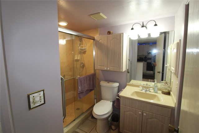 bathroom with vanity, walk in shower, tile patterned flooring, and toilet