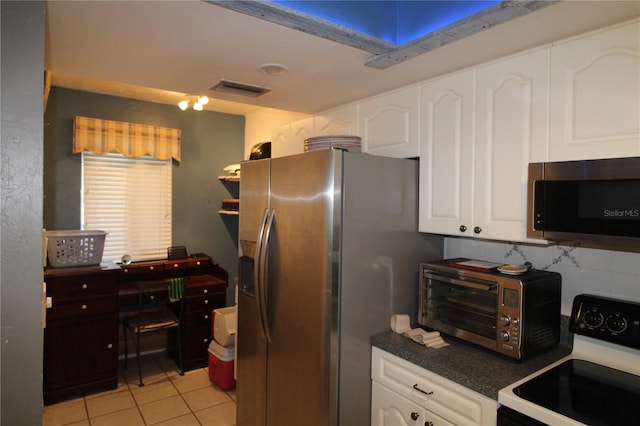 kitchen with white cabinetry, light tile patterned floors, and stainless steel appliances