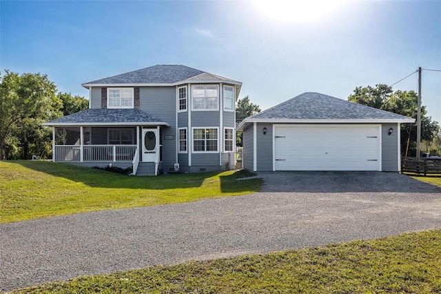 view of front of home featuring a porch, a front lawn, and a garage