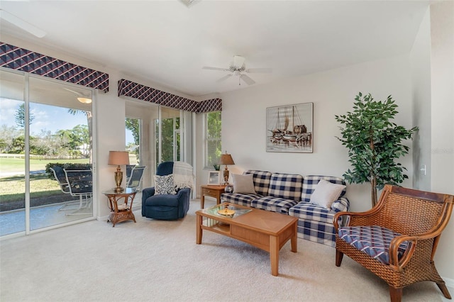 carpeted living room with ceiling fan