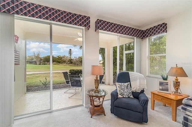 sunroom with ceiling fan and plenty of natural light