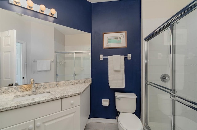 bathroom featuring walk in shower, tile patterned floors, vanity, and toilet