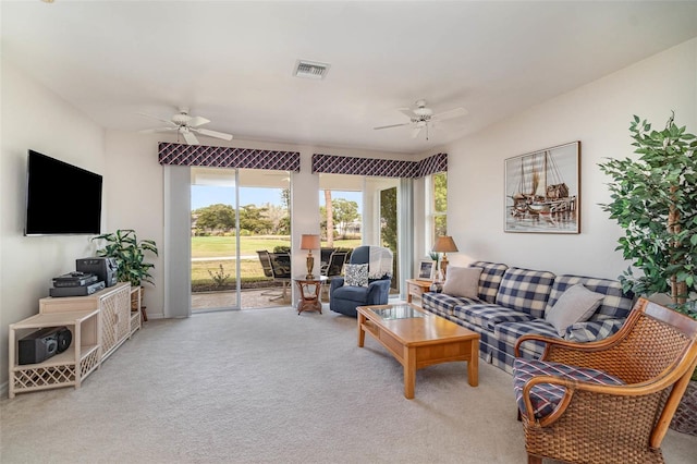 carpeted living room with ceiling fan