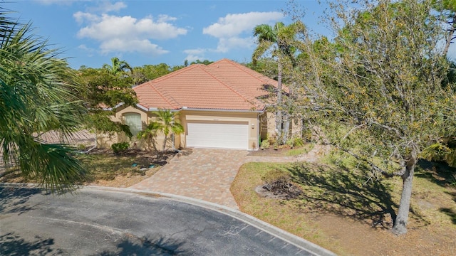 mediterranean / spanish-style home featuring a garage