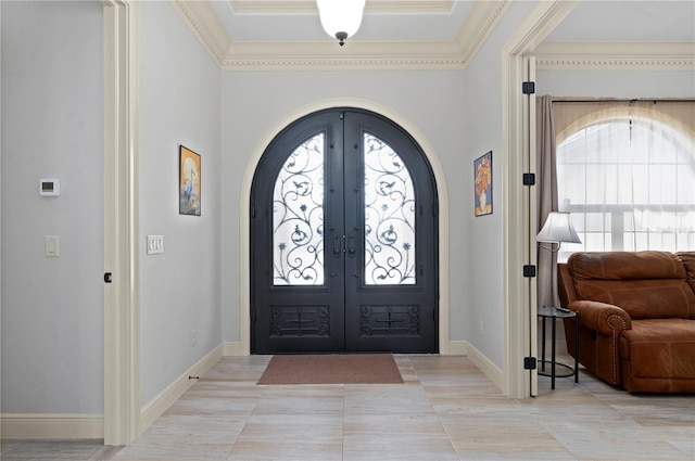 entrance foyer with french doors, ornamental molding, and light tile floors